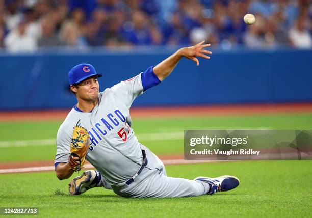 Brendon Little of the Chicago Cubs throws to first base but is too late as Matt Chapman gets an infield single in the sixth inning against the...