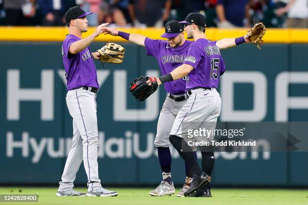 Sean Bouchard, Garrett Hampson and Randal Grichuk of the Colorado Rockies celebrate their 3-2 victory over the Atlanta Braves at Truist Park on...