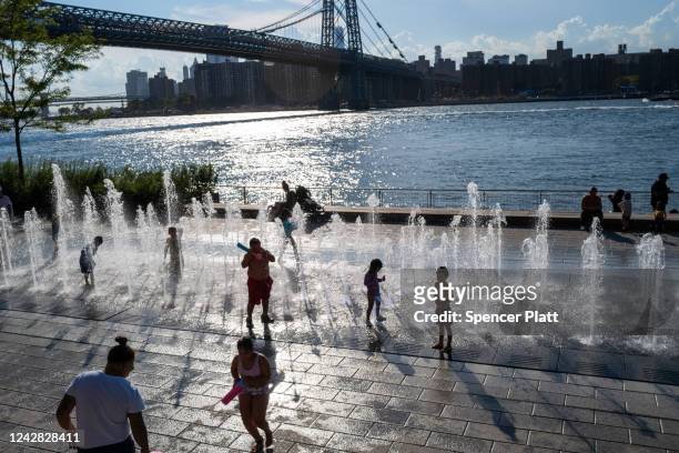 Children and adults enjoy the warm weather at Domino Park on August 30, 2022 in the Brooklyn borough of New York City. Temperatures are expected to...