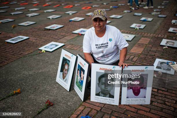 Dania Arroyave Bonilla, poses with the portraits of Pedro Nel Arroyave, her father and her siblings all victims of forced dissapearances during the...