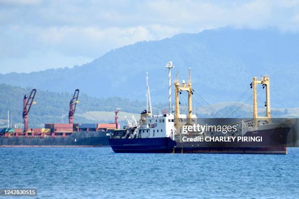 This picture taken on August 30 shows ships anchored near the Honiara port of Solomons Island. - A snap ban on foreign military vessels docking in...