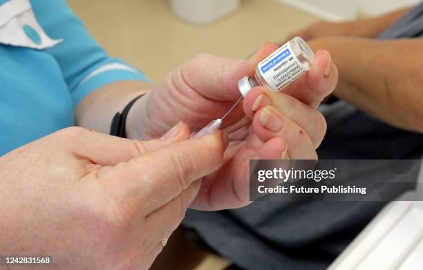 Healthcare worker draws a dose from a vial during the COVID-19 vaccination campaign in Dnipro, central Ukraine.