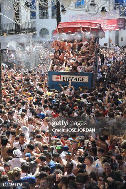 Revellers covered in tomato pulp take part in the annual "Tomatina" festival in the eastern town of Bunol, on August 31, 2022. - The iconic fiesta,...