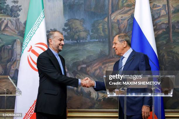 Russian Foreign Minister Sergei Lavrov and Iranian Foreign Minister Hossein Amir-Abdollahian shake hands during a joint news conference as part of...