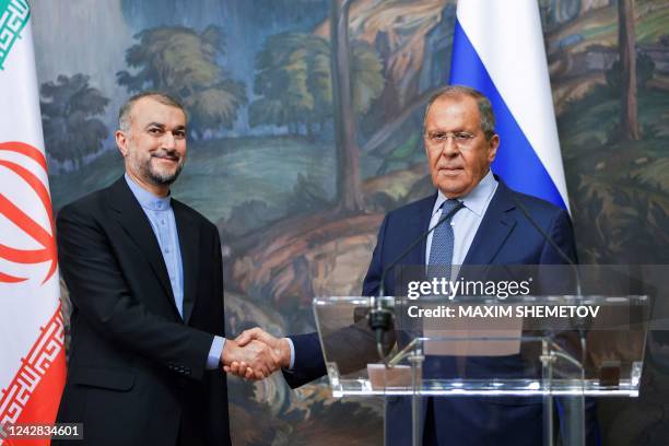 Russian Foreign Minister Sergei Lavrov and Iranian Foreign Minister Hossein Amir-Abdollahian shake hands during a joint news conference as part of...