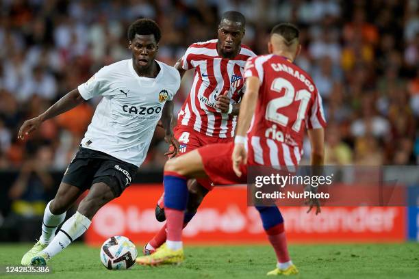 Yunus Musah central midfield of Valencia and United States and Yannick Carrasco left winger of Atletico de Madrid and Belgium compete for the ball...