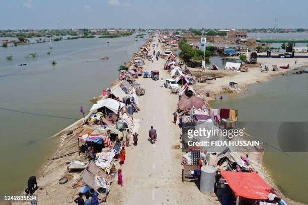 This aerial photograph taken on August 31, 2022 shows flood-affected people taking refuge in a makeshift camp after heavy monsoon rains in Jaffarabad...