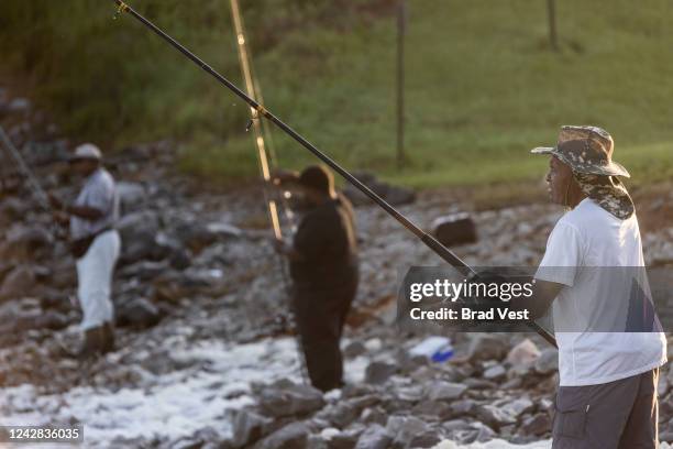 Dr. Earl Wolfe, right, fishes in the Pearl River People near the spillway on August 31, 2022 in Jackson, Mississippi. Jackson, Mississippi, the...