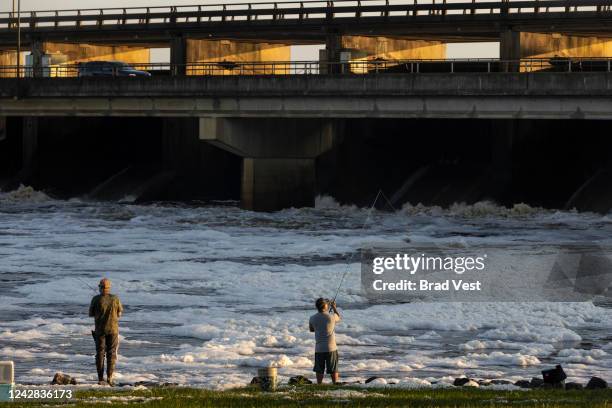 People fish in the Pearl River near the spillway on August 31, 2022 in Jackson, Mississippi. Jackson, Mississippi, the state’s capital, is currently...