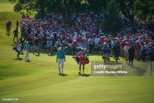 The crowd watches as Rory McIlroy and Scottie Scheffler walk up the 18th fairway during the final round of the TOUR Championship at East Lake Golf...