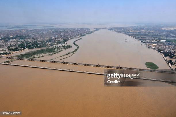 This aerial photograph taken on August 31, 2022 shows flooded river Indus along the Sukkur Barrage after heavy rains in flood hit Sukkur of Sindh...