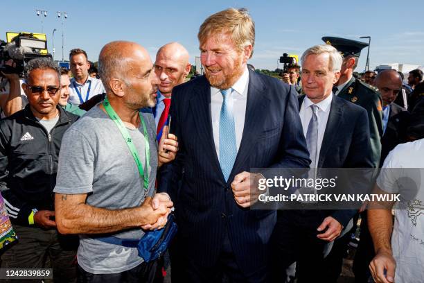 King Willem-Alexander of The Netherlands listens to explainations during a working visit to the asylum seekers' center in Ter Apel, on August 31,...