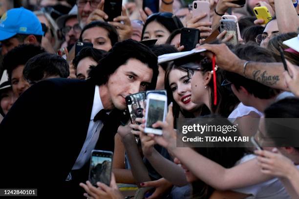 Actor Adam Driver poses for selfie photos as he arrives for the Opening Ceremony and the screening of the film "White Noise" on August 31, 2022...