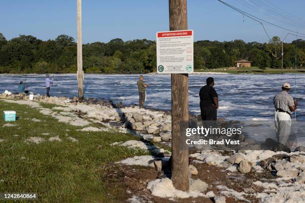 People fish in the Pearl River near the spillway on August 31, 2022 in Jackson, Mississippi. Jackson, Mississippi, the state’s capital, is currently...