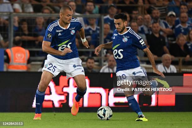 Strasbourg's Franco-Croatian midfielder Adrien Thomasson drives the ball past Strasbourg's French forward Ludovic Ajorque during the French L1...