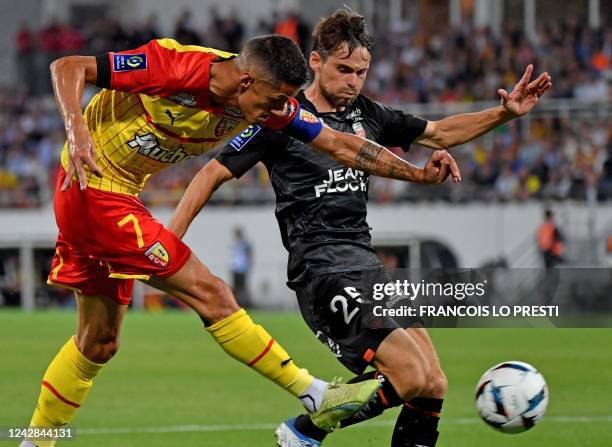 Lens' French forward Florian Sotoca kicks the ball past Lorient's French defender Vincent Le Goff during the French L1 football match between RC Lens...