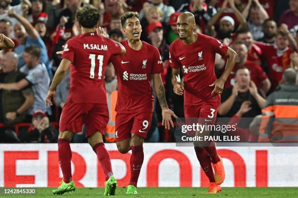 Liverpool's Brazilian striker Roberto Firmino celebrates with teammates after scoring their firts goal during the English Premier League football...