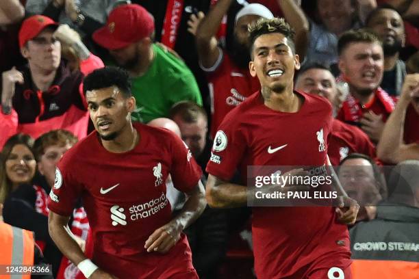 Liverpool's Brazilian striker Roberto Firmino celebrates after scoring their firts goal during the English Premier League football match between...