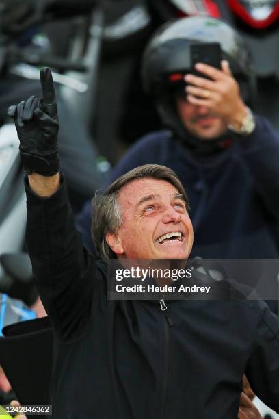 President of Brazil Jair Bolsonaro greets supporters in a motorcade during a campaign rally ahead of the Presidential Elections on August 31, 2022 in...