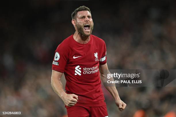 Liverpool's English midfielder James Milner celebrates on the pitch after the English Premier League football match between Liverpool and Newcastle...