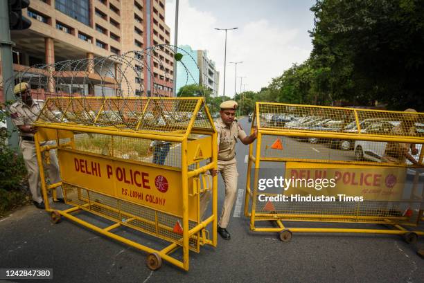 Delhi Police officials put up barricades as the MLAs from Aam Aadmi Party arrive to file a complaint against BJP outside the CBI Headquarters at CGO...