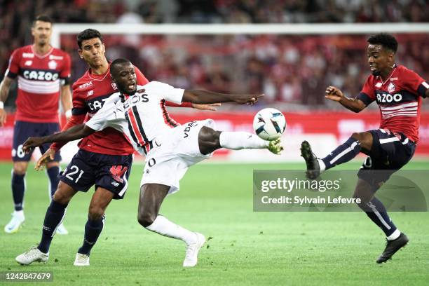 Nicolas Pepe of OGC Nice is challenged by Benjamiin Andre of Lille OSC and Adilson Angel abreu de Almeida Gomes of Lille OSC during the Ligue 1 match...