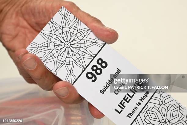 Bookmark for children with the 988 suicide and crisis lifeline emergency telephone number is displayed by Lance Neiberger, a volunteer with the...