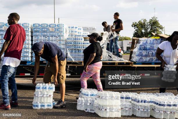 Cases of bottled water are handed out at a Mississippi Rapid Response Coalition distribution site on August 31, 2022 in Jackson, Mississippi. Jackson...