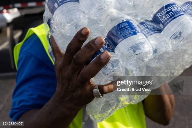 Cases of bottled water are distributed to residents at a Mississippi Rapid Response Coalition distribution site on August 31, 2022 in Jackson,...