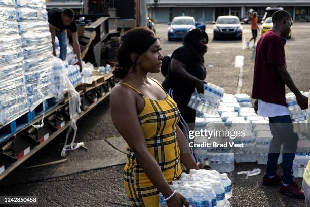 Aelicia Hodge helps hand out cases of bottled water at a Mississippi Rapid Response Coalition distribution site on August 31, 2022 in Jackson,...