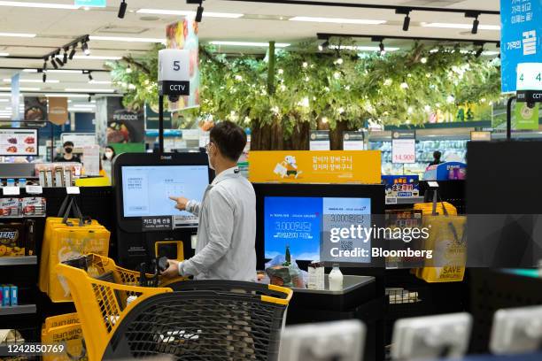 Customer pays for a purchase with a self-service kiosk at an E-Mart Inc. Store in Seoul, South Korea, on Tuesday, Aug 2022. South Korea is scheduled...