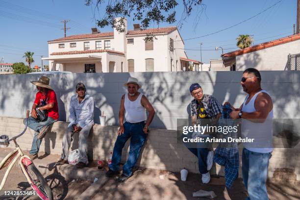 Group of men sit underneath a tree for shade amid a heatwave on August 31, 2022 in Calexico, California. The National Weather Service issued...