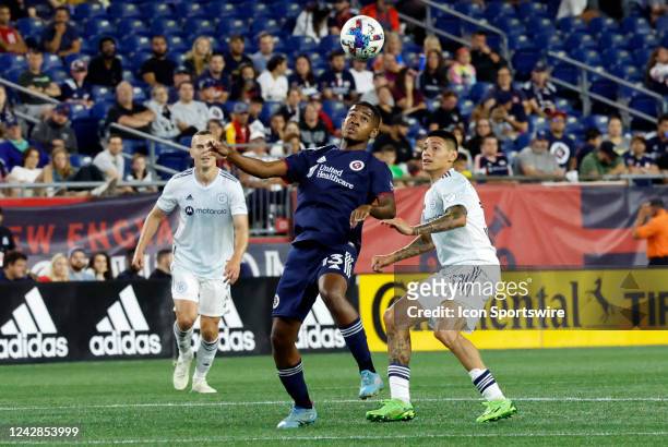 New England Revolution midfielder Lucas Maciel Felix looks to control the ball in front of Chicago Fire FC defensive midfielder Federico Navarro...