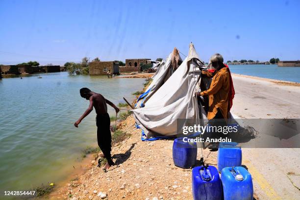 Pakistani flood victims are being evacuated to a safer place following a flash flood in Sewan Sharif, southern Sindh province, Pakistan on September...