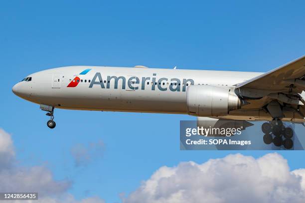 Boeing 777-300ER aircraft of American Airlines arriving at London Heathrow Airport. The wide-body Boeing 777 airplane has the tail number N734AR....
