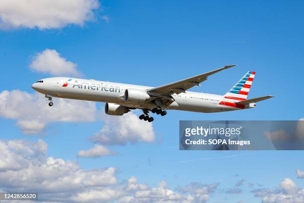 Boeing 777-300ER aircraft of American Airlines arriving at London Heathrow Airport. The wide-body Boeing 777 airplane has the tail number N734AR....
