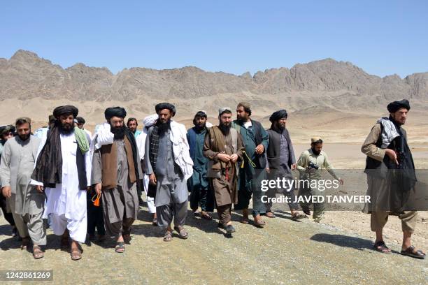 Officials of the Ministry of Rural Rehabilitation and Development arrive to inaugurate a dam at Miankoh village in Kandahar on September 1, 2022.