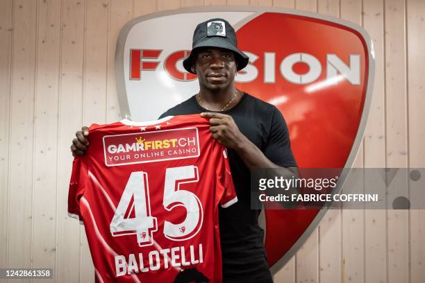 Italy's football striker Mario Balotelli poses with his new jersey on September 1 after he signed a two-year contract with Swiss side FC Sion, the...