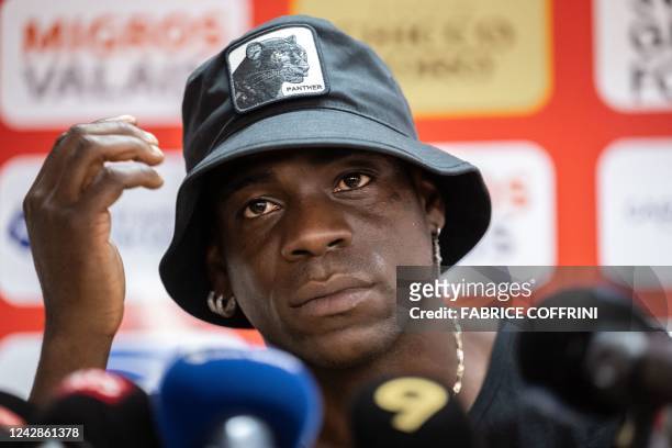 Italy's football striker Mario Balotelli gestures at a press conference on September 1 after he signed a two-year contract with Swiss side FC Sion,...