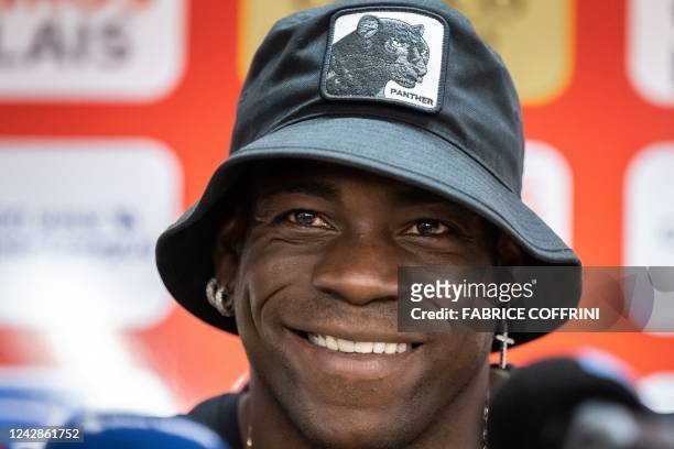 Italy's football striker Mario Balotelli smiles at a press conference on September 1 after he signed a two-year contract with Swiss side FC Sion, the...