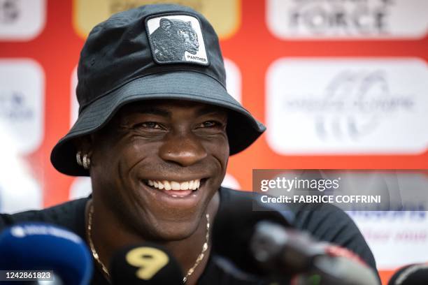 Italy's football striker Mario Balotelli smiles at a press conference on September 1 after he signed a two-year contract with Swiss side FC Sion, the...