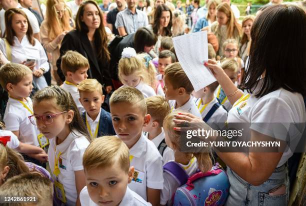 Pupils of the first grade attend the first lesson of the new school year in the western Ukrainian city of Lviv on September 1, 2022. - Ukrainian...