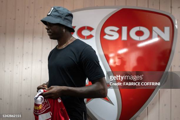 Italy's football striker Mario Balotelli holds his new jersey on September 1 after he signed a two-year contract with Swiss side FC Sion, the 11th...