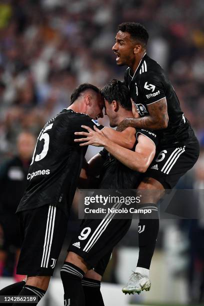 Dusan Vlahovic of Juventus FC celebrates with Federico Gatti and Danilo Luiz da Silva of Juventus FC after scoring the opening goal from a free kick...