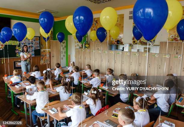 Pupils of the first grade attend the first lesson of the new school year in the western Ukrainian city of Lviv on September 1, 2022. - Ukrainian...