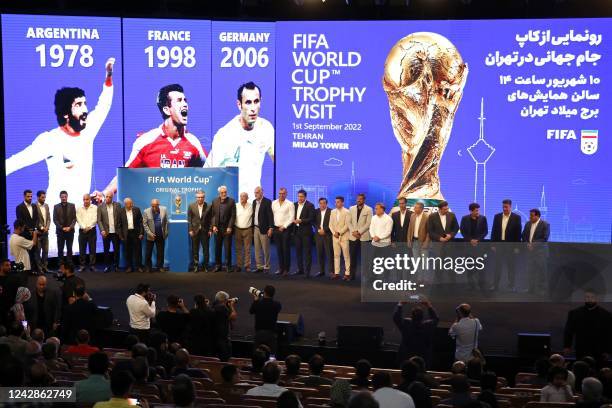 Officials pose on stage with the FIFA World Cup Trophy at Milad Tower complex in Tehran September 1, 2022 as part of the global trophy tour.