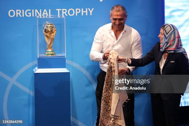 Former Iranian goalkeeper Ahmadreza Abedzadeh poses after unveiling the FIFA World Cup Trophy at a hall in Milad Tower complex, in Tehran, Iran...