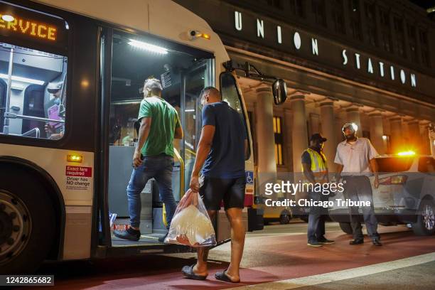 Group of migrants board a CTA bus at Chicago&apos;s Union Station to be taken to a Salvation Army shelter after arriving from Texas on Aug. 31, 2022.