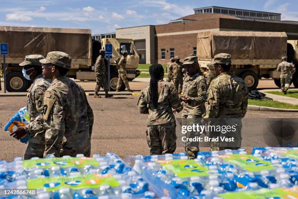 Members of the Mississippi National Guard hand out bottled water at Thomas Cardozo Middle School in response to the water crisis on September 01,...