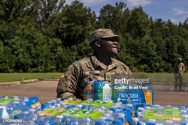 Members of the Mississippi National Guard hand out bottled water at Thomas Cardozo Middle School in response to the water crisis on September 01,...